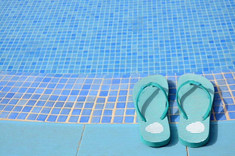 Horizontal view for tropical swimming pool details with women's flip flops on a side. Horizontal view for tropical swimming pool details with women's flip flops on a side