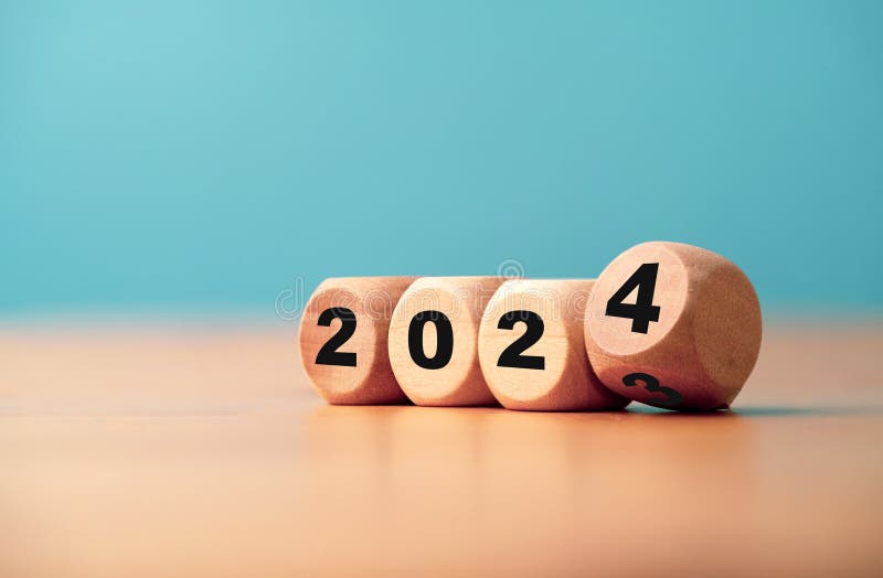 2024 Block Over 2023 and 2022 Wooden Building on Table Background