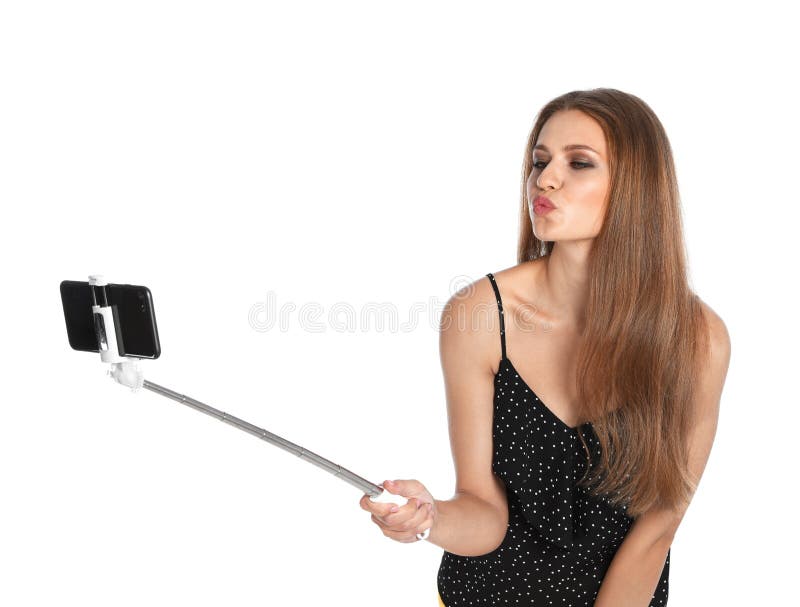 Flirty młoda kobieta bierze selfie na bielu obraz royalty free Flirty młoda kobieta bierze selfie na bielu obraz royalty free