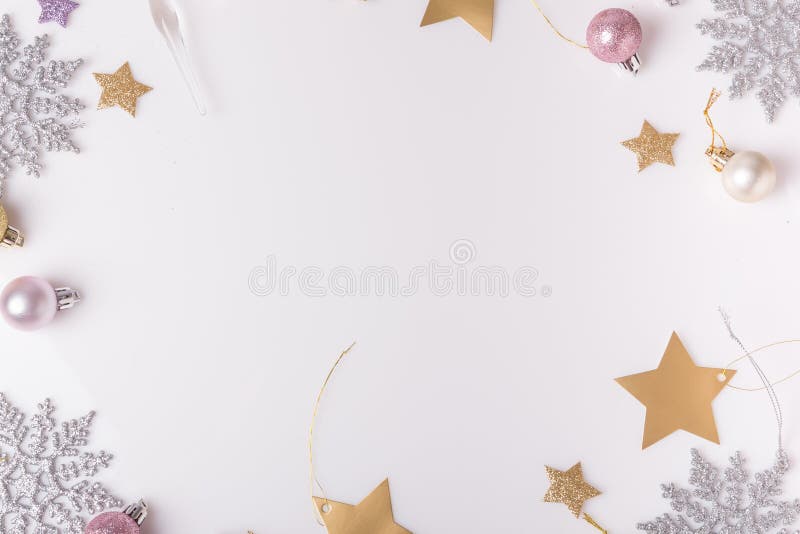 Christmas holiday composition. Festive creative gold silver pattern, xmas pink decor holiday ball with ribbon, snowflakes on white background. Flat lay, top view. Christmas holiday composition. Festive creative gold silver pattern, xmas pink decor holiday ball with ribbon, snowflakes on white background. Flat lay, top view