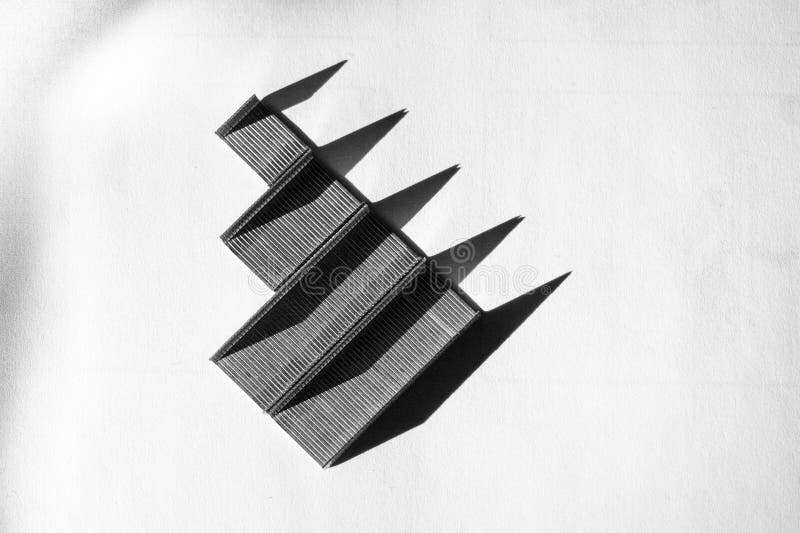 Floating black rectangular shapes made of staples in a diagonal arrangement stock photography