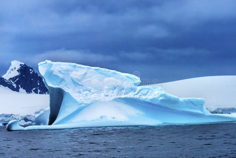 Floating Blue Iceberg Snow Glaciers Mountains Charlotte Harbor Antarctica royalty free stock images Floating Blue Iceberg Snow Glaciers Mountains Charlotte Harbor Antarctica royalty free stock images