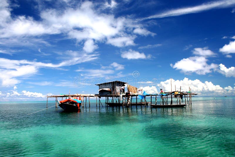 Floating house on turquoise lagoon