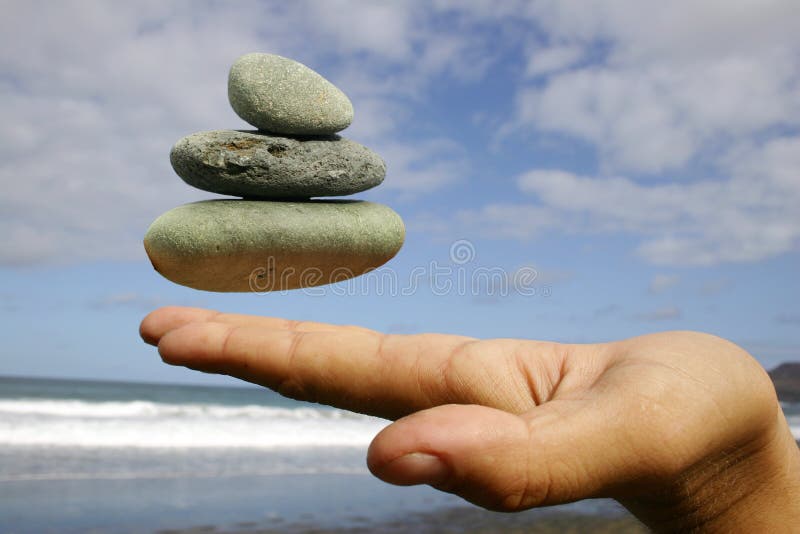 Floating Pebbles. Hand and floating pebbles on the beach Floating Pebbles. Hand and floating pebbles on the beach