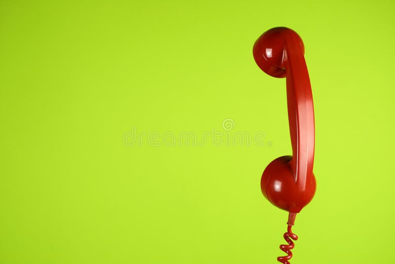 Floating Phone handset against a light green wall.
