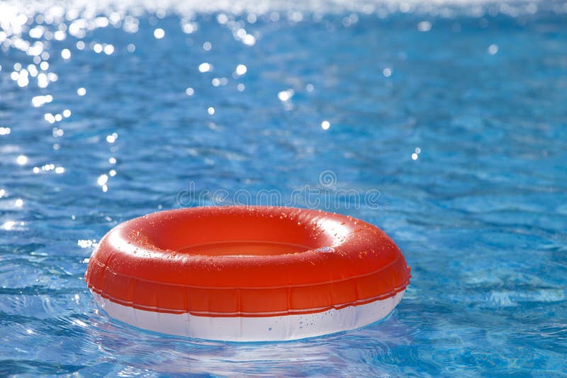 Floating ring on blue water swimpool stock photo