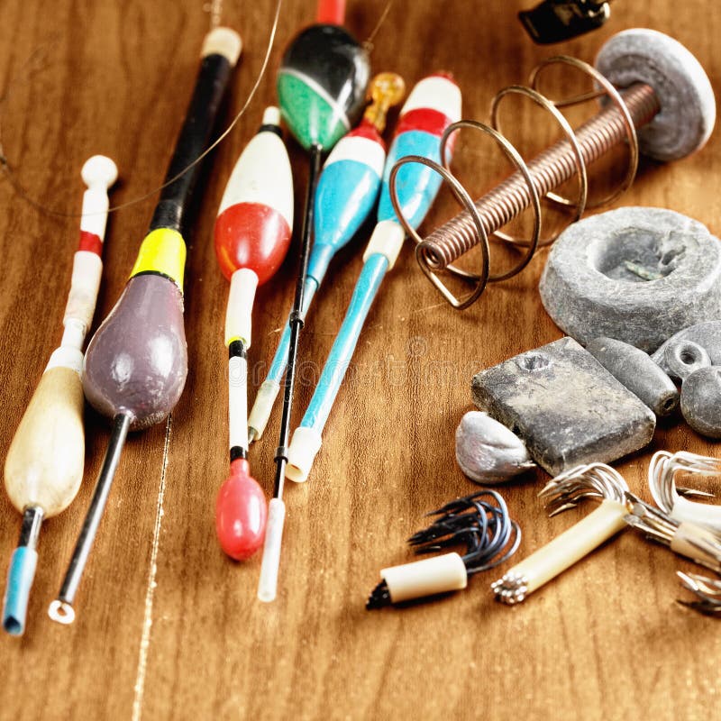 Floats, Sinkers, Hooks and Reel with Fishing Line on the Table. Stock