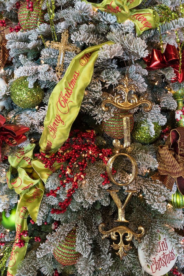 Christmas Tree Decorated with Merry Christmas Garland and the Word Joy