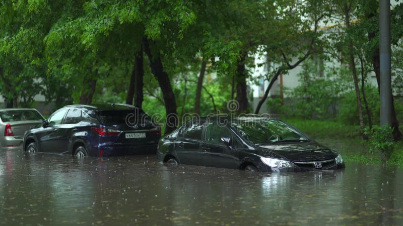 Flooded cars on the street of the city. Street after heavy rain. Water could enter the engine, transmission parts or other places