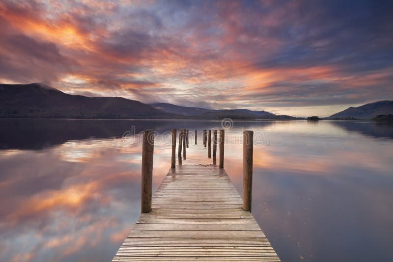 Flooded jetty in Derwent Water, Lake District, England at sunset