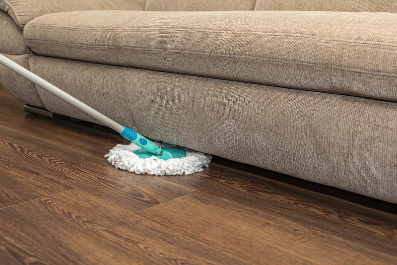 Floor cleaning and disinfection, house wet cleaning. Washing vinyl brown floor with a round mop, house cleaning, place