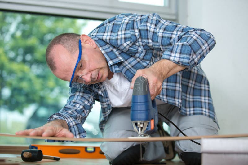 Floor Installer Cutting Floorboard with Jigsaw Stock Photo Image of