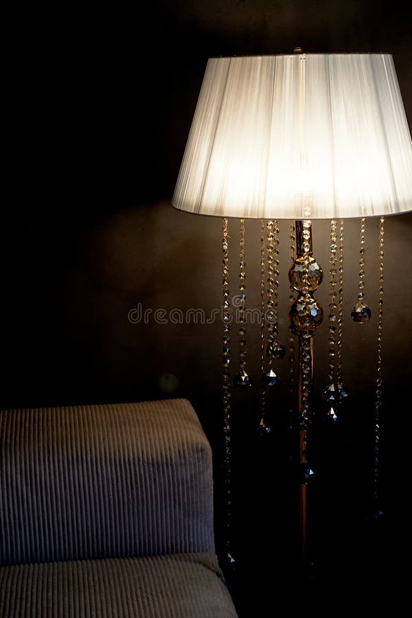 Floor lamp with crystal pendants. Sophisticated minimalist interior. Taste royalty free stock photos