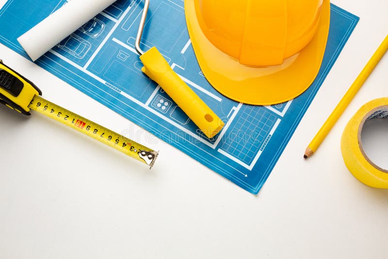 Floor plan, hard hat, tape measure, construction tools on a white background royalty free stock photo Floor plan, hard hat, tape measure, construction tools on a white background royalty free stock photo