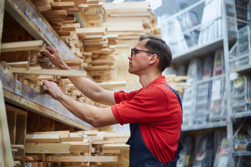 Flooring Store Salesman with Laminate Floor Sample Panel. Stock Photo