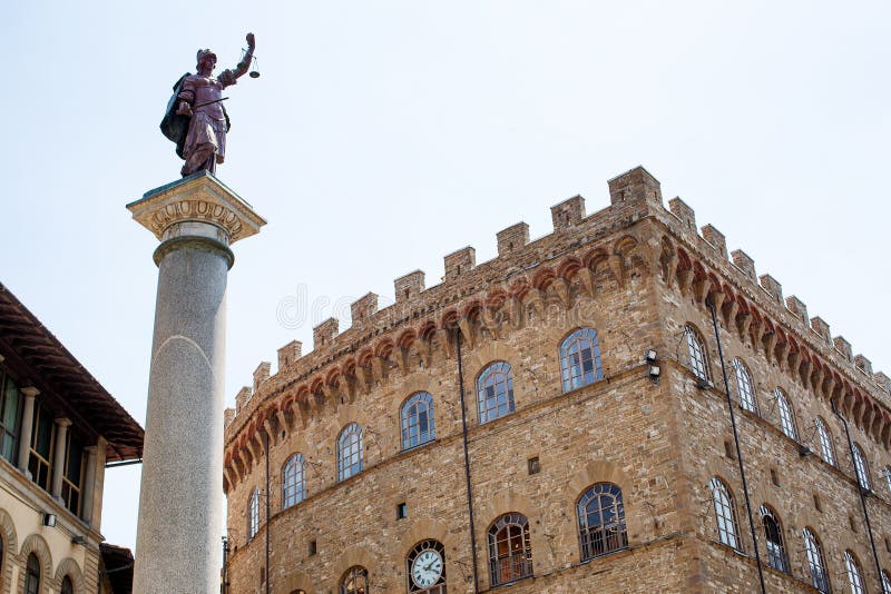 Florence, Italy, June 3, 2019: Column of Justice is an ancient Roman marble Doric column re-erected by the Medici dynasty in the Renaissance as a free standing victory monument with a porphyry statue of Justice at the top. It stands in the Piazza Santa Trinita, Florence. Florence, Italy, June 3, 2019: Column of Justice is an ancient Roman marble Doric column re-erected by the Medici dynasty in the Renaissance as a free standing victory monument with a porphyry statue of Justice at the top. It stands in the Piazza Santa Trinita, Florence