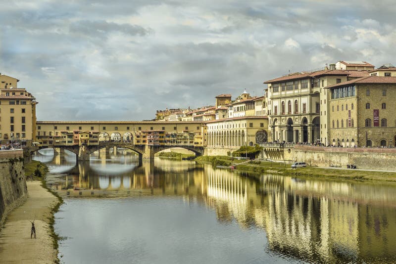 Florence pontevecchio bridge in a cloudy autumn morning. With historical medieval palace reflecting on the river water royalty free stock images Florence pontevecchio bridge in a cloudy autumn morning. With historical medieval palace reflecting on the river water royalty free stock images