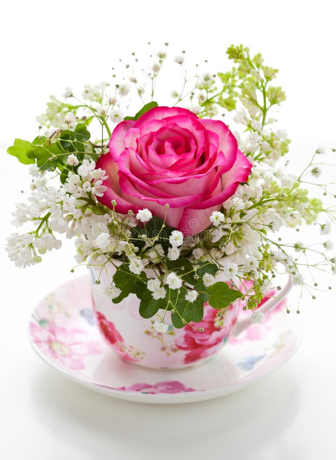 Pink rose and white lilac in a cup. Pink rose and white lilac in a cup