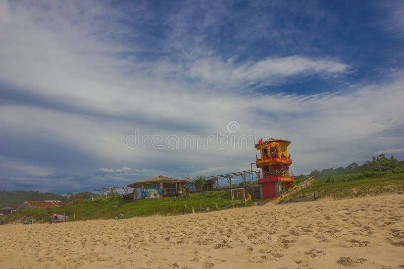 FLORIANOPOLIS, BRAZIL - MAY 08, 2016: colorfull liefguard hut in the beach with nice blue cloudy sky as background stock images FLORIANOPOLIS, BRAZIL - MAY 08, 2016: colorfull liefguard hut in the beach with nice blue cloudy sky as background stock images