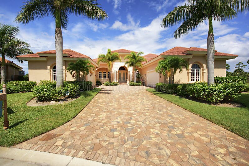 Florida luxury home with paver block driveway