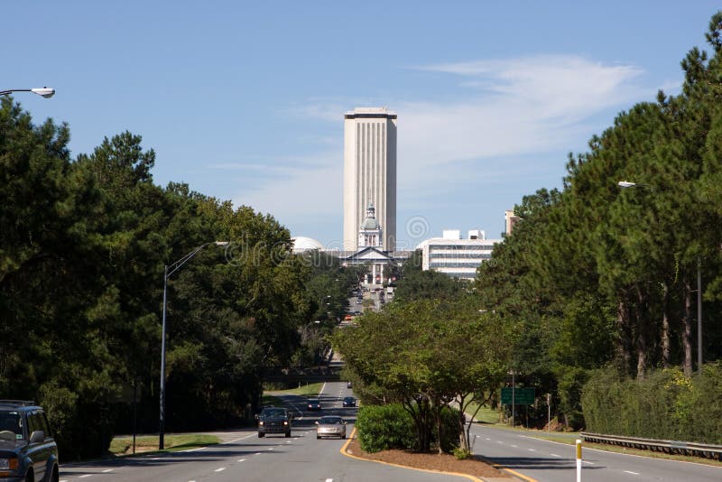 The new Florida State Capital building towers above the old capital which sit below it and is now a state museum in Tallahassee, Florida. View is looking west up the Apalachee Parkway. The new Florida State Capital building towers above the old capital which sit below it and is now a state museum in Tallahassee, Florida. View is looking west up the Apalachee Parkway.