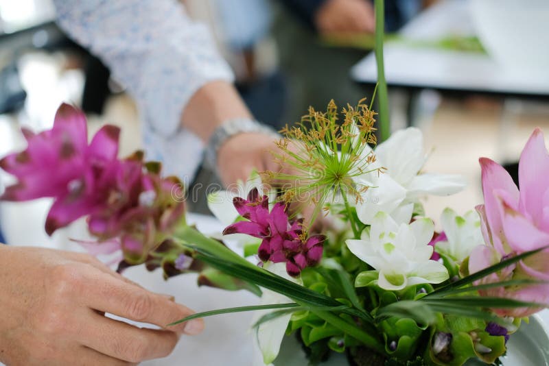 Florist Arranging Flower Bouquet in Vase. Floristry Class Course Florist Arranging Flower Bouquet in Vase. Floristry Class Course