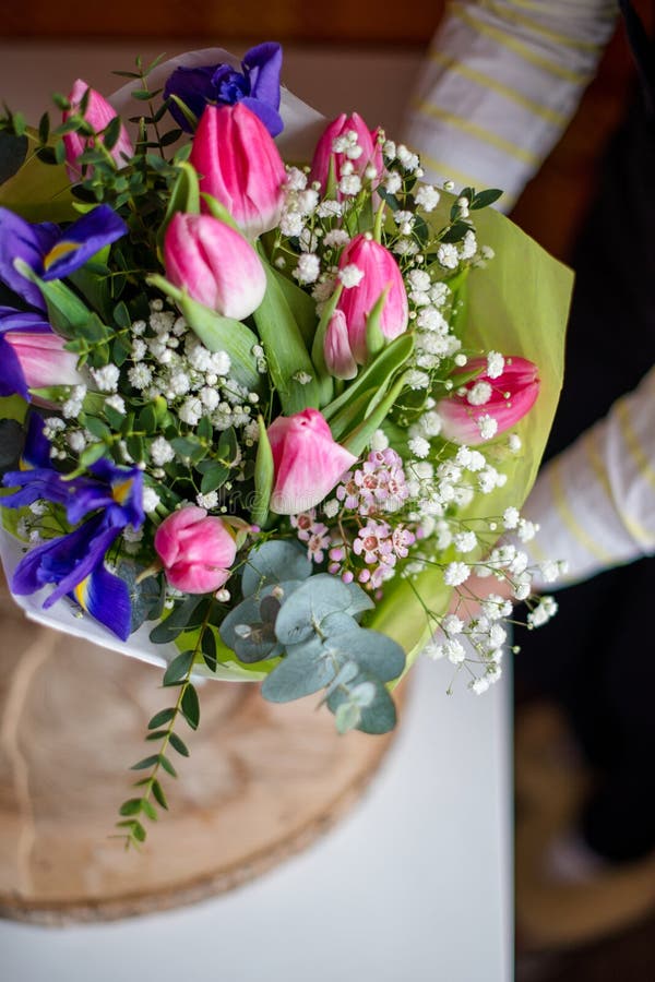 Florist Hands Showing Bouquet of Spring Flowers. Selective Focus. Stock