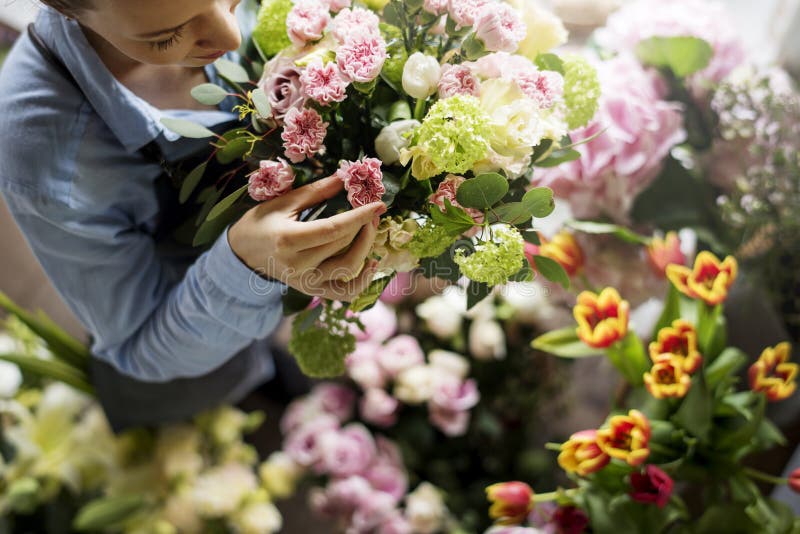 Florist Making a Bouquet of Beautiful Branches with Red Berries and