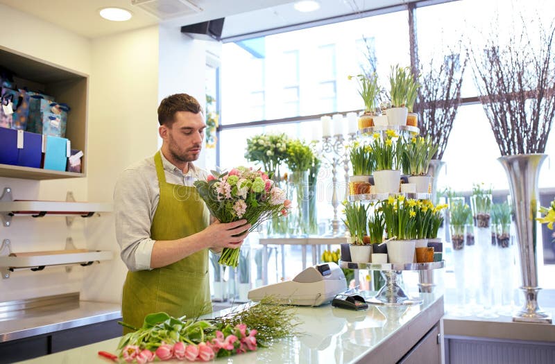 Florist man making bunch at flower shop