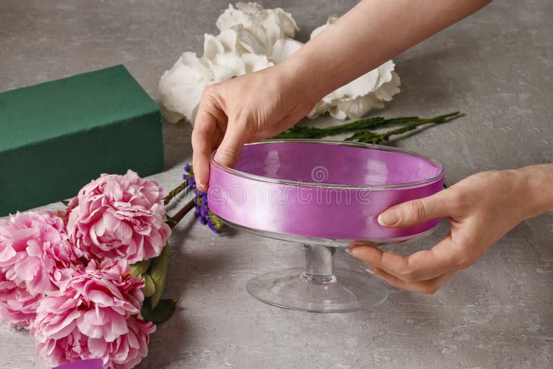 Florist at work: woman arranging floral decorations