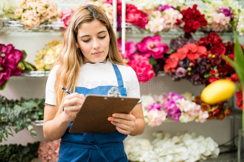Florist working on a flower inventory royalty free stock photo Florist working on a flower inventory royalty free stock photo