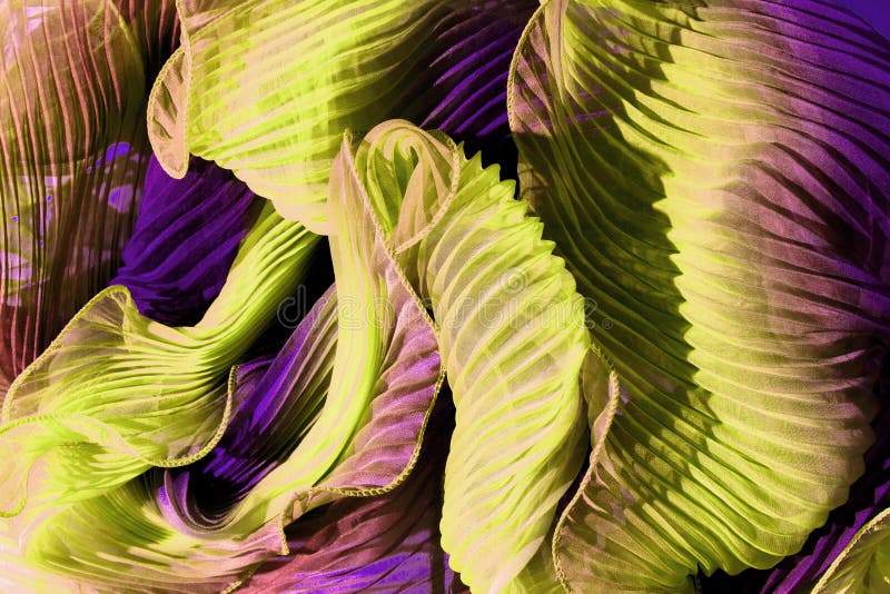 Flounces of yellow violet fabric wound by waves. stock images Flounces of yellow violet fabric wound by waves. stock images