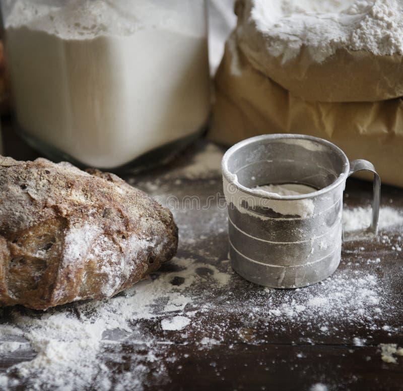 Flour and bread on a messy kitchen top royalty free stock photography