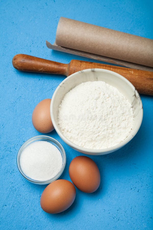 Flour, Eggs, Butter, Sugar On A Blue Background, Vertically Stock Image