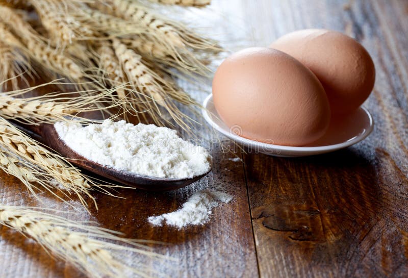 Flour on spoon and eggs