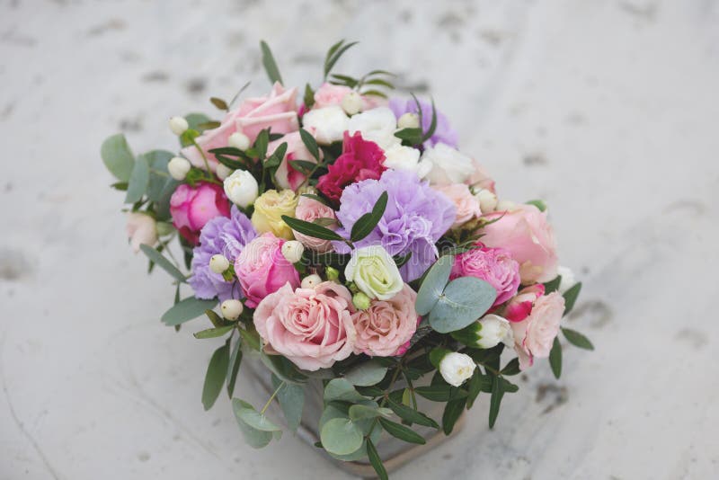 Flower arrangement in a box with spray pink roses, succulent, eustoma, white hypericum, eucaliptus