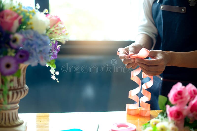 flower artist woman working to decorate  artificial flowers