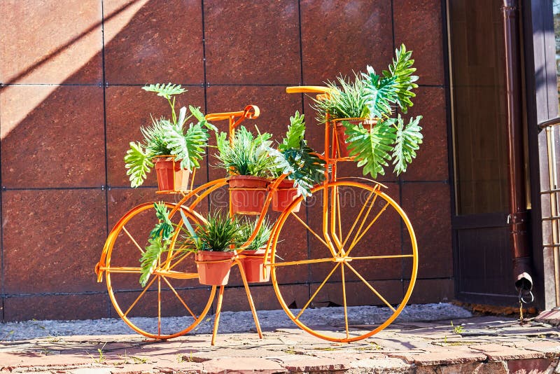 Flower Bed in the Form of a Bicycle with Flowers in Pots Stock Image