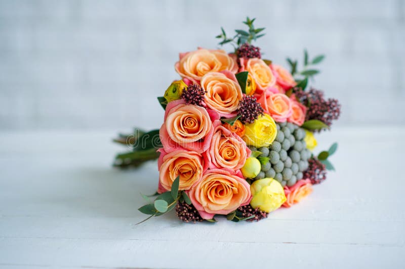 Flower bouquet with orange roses and yellow ranunculus