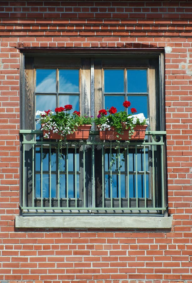 Flower Box at Window Red Brick Wall on Sunny Day Sky Reflections Stock