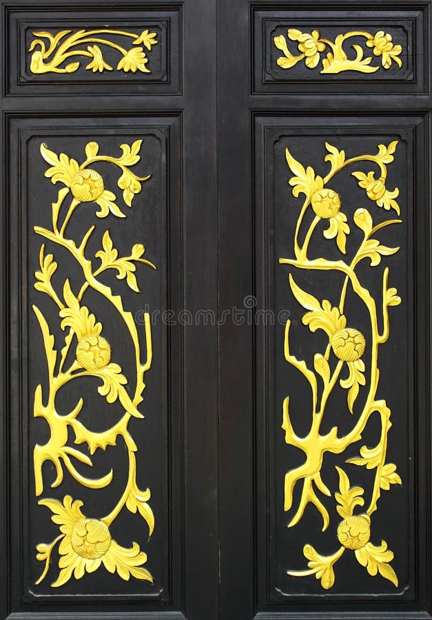 Flower carved gold paint on wood door