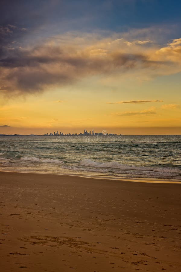 Flower In The Sand. Somebody has drawn a flower on the sand at Coolangatta, Queensland, Australia. The skyline of the city of Gold Coast is seen in the distance stock images Flower In The Sand. Somebody has drawn a flower on the sand at Coolangatta, Queensland, Australia. The skyline of the city of Gold Coast is seen in the distance stock images