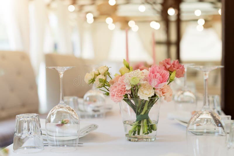 Flower table decorations for holidays and wedding dinner. Table set for holiday, event, party or wedding reception in