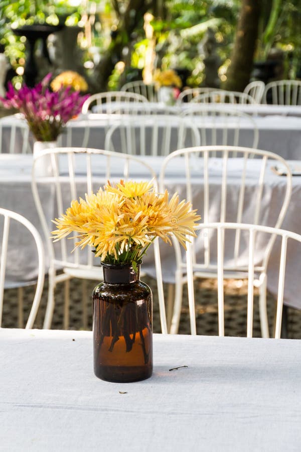 Flower Vase On Dining Table Stock Photo - Image of yellow, plant: 50176884
