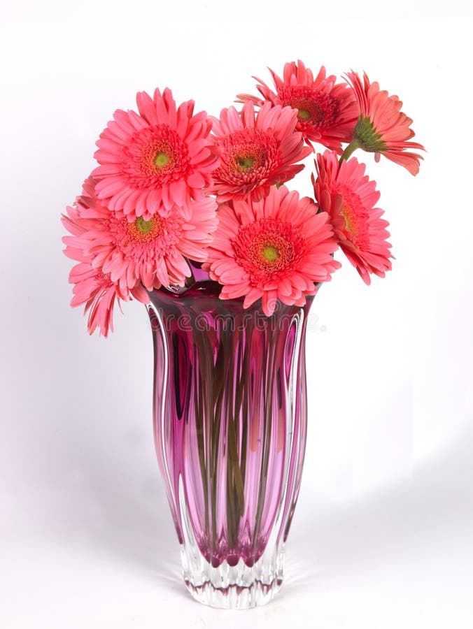 a flower vase with pink daisy flowers