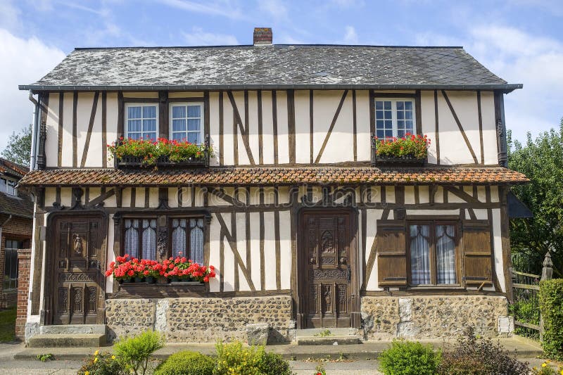 Flowered window of old house in Normandy