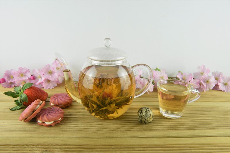 Flowering tea with strawberry pink biscuits or cookies