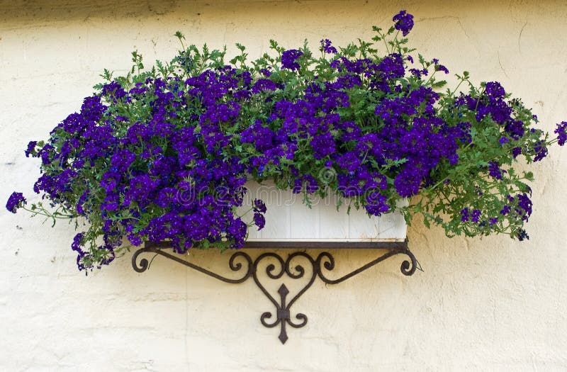 Beautiful classical design planter flowerpot on a bricks wall. Beautiful classical design planter flowerpot on a bricks wall