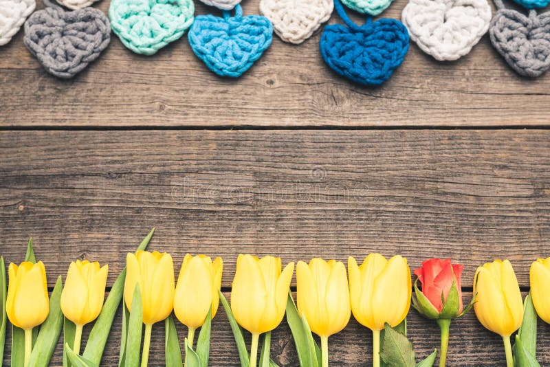 Flowers arranged on old boards and hearts of yarn. stock photo Flowers arranged on old boards and hearts of yarn. stock photo