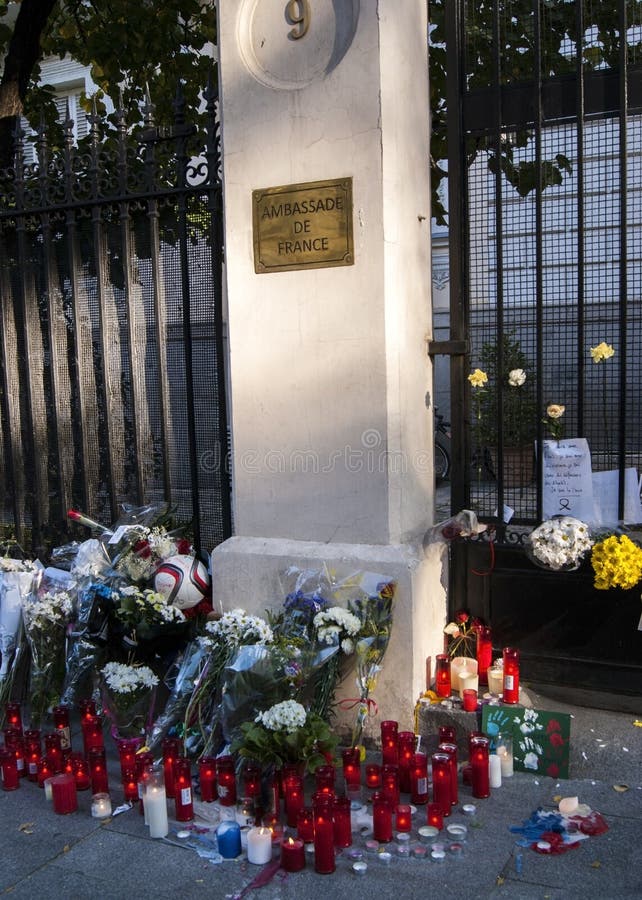 Flowers, candles and signs against terrorist attack in Paris, placed in front of French embassy in Madrid, Spain royalty free stock photos Flowers, candles and signs against terrorist attack in Paris, placed in front of French embassy in Madrid, Spain royalty free stock photos